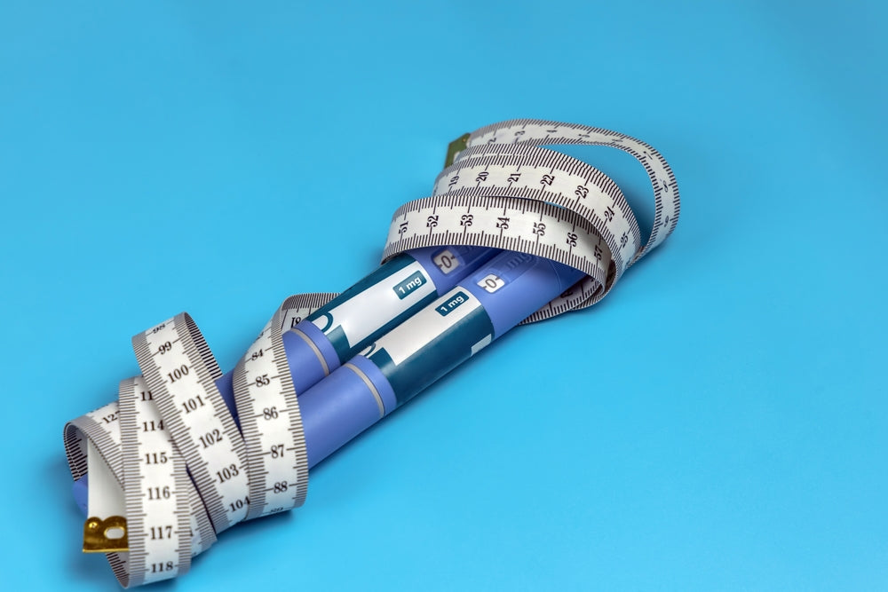 Mounjaro Ozempic Wegovy and Hair Loss - injections wrapped in tape measure