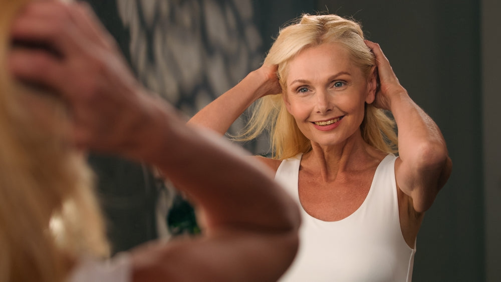 Lady running fingers through healthy hair showing good hair care
